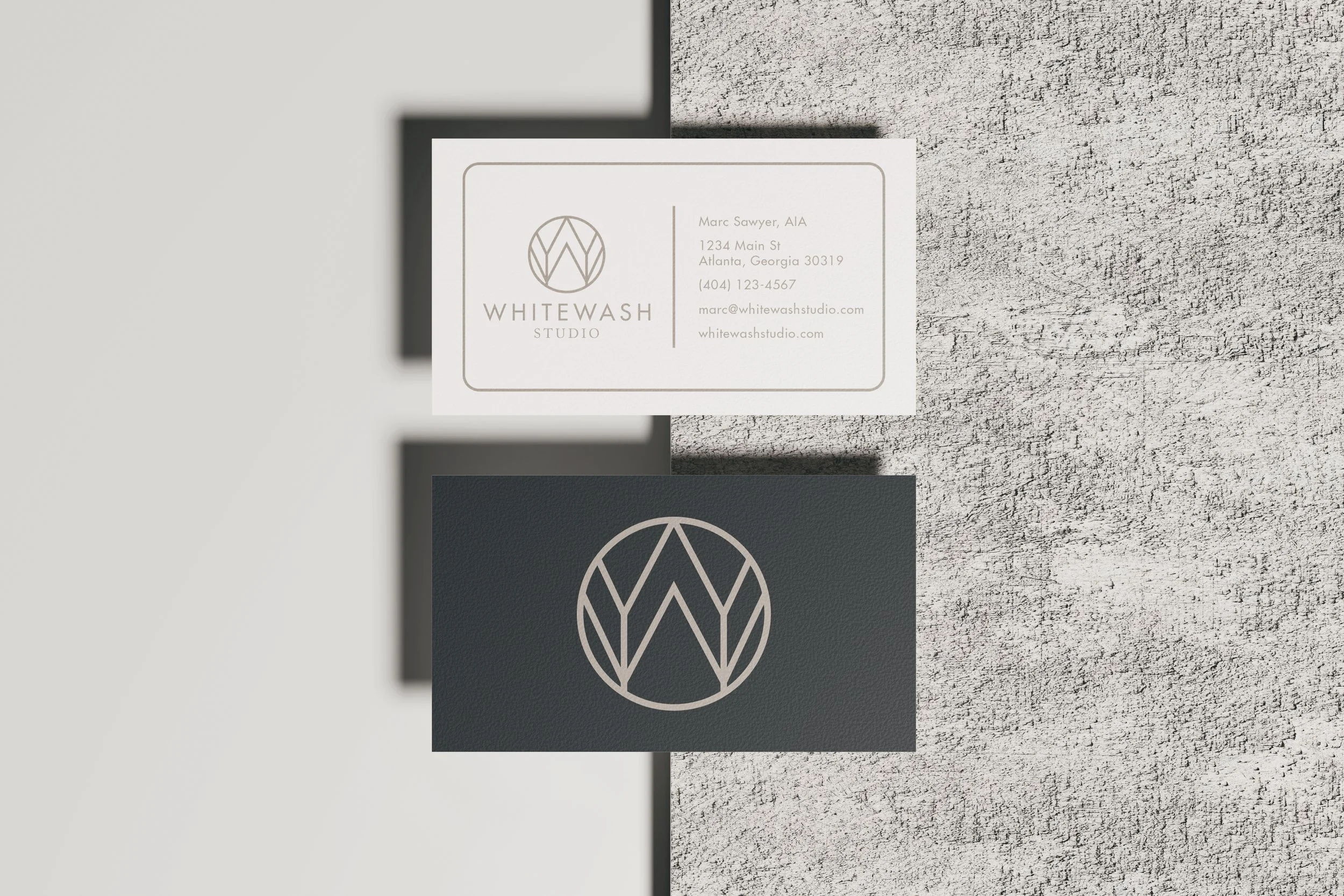 Whitewash Studio business cards showing white front and dark back with logo mark