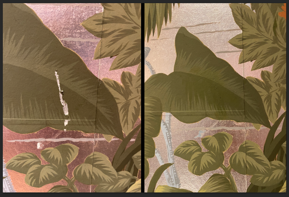 Close-up view of a decorative mural of de Gournay wallpaper featuring large green leaves and smaller patterned leaves with a brick wall background.
