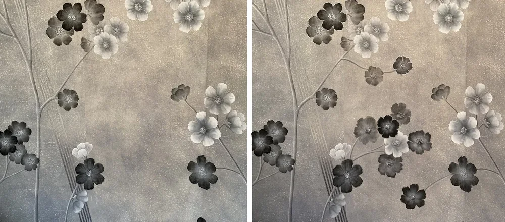 Black and white floral wallpaper with flowers and branches.