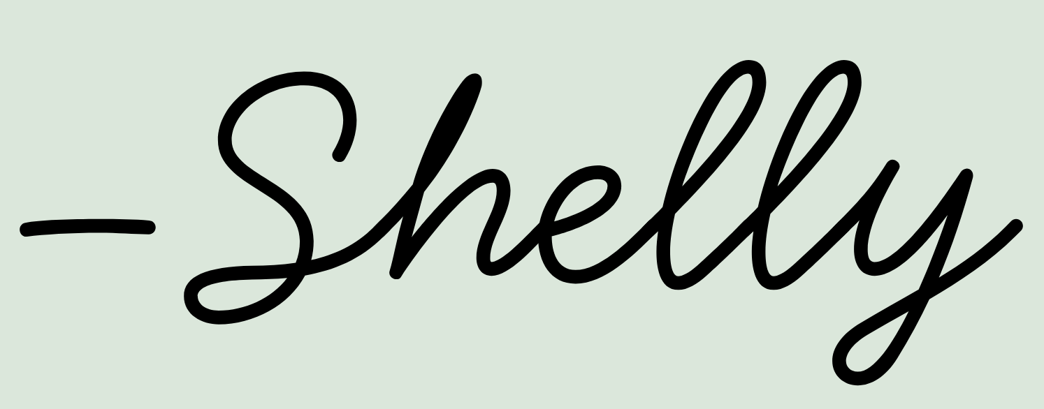 Stylized black handwritten text reading '-Shelly' on a light green background.