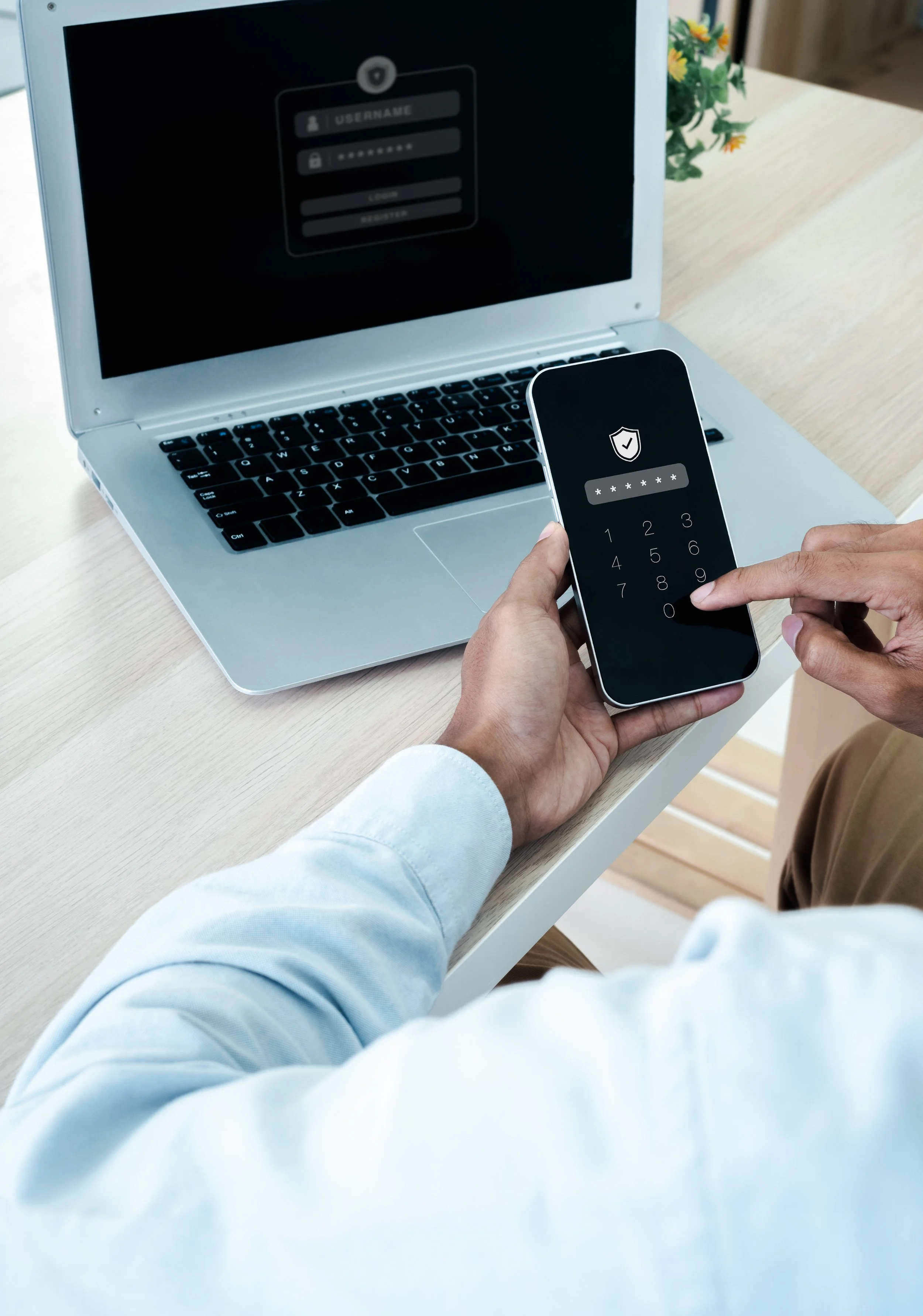 Man logging into phone and computer using password encryption for personal financial administrative support