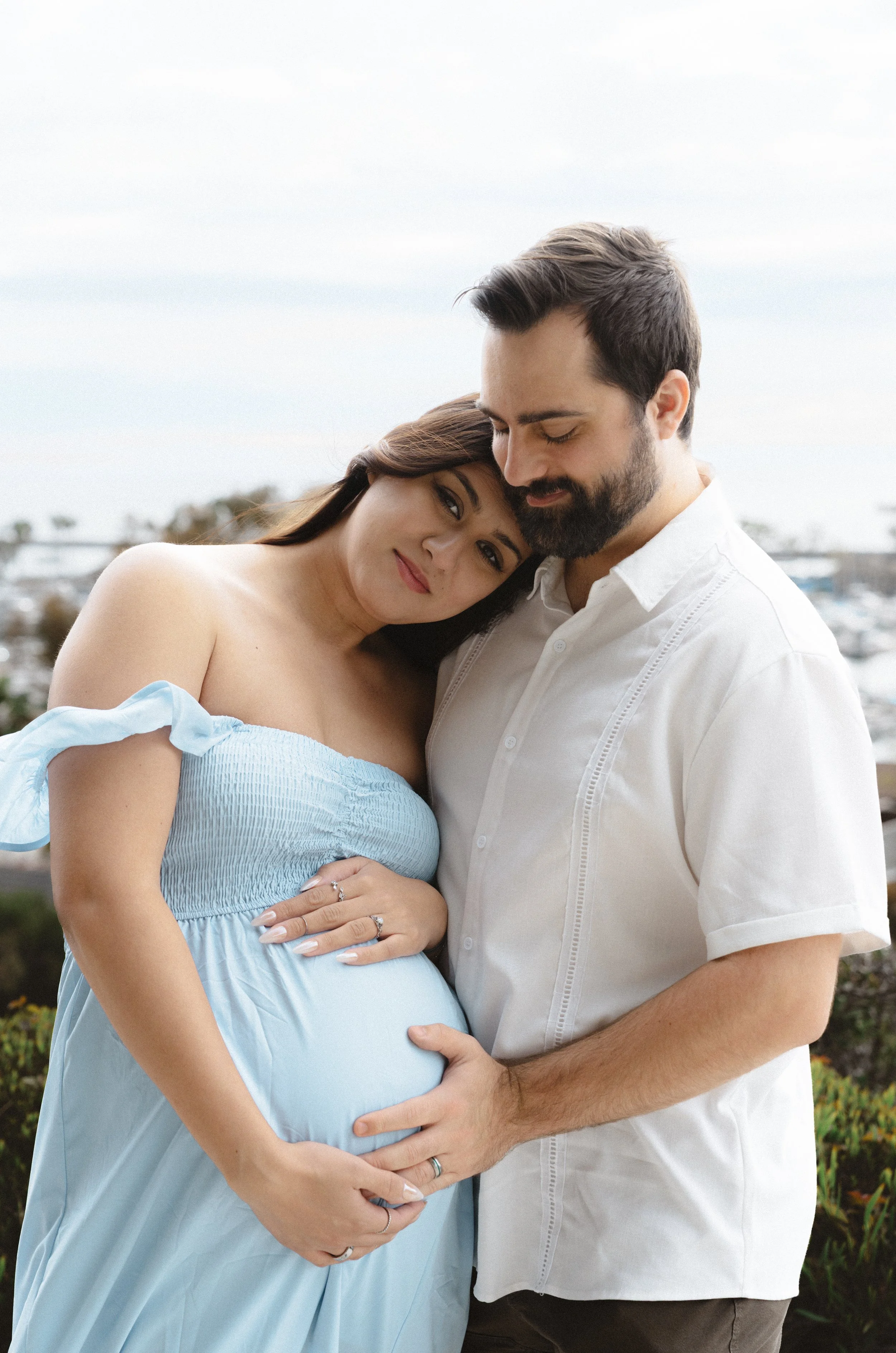 Maternity couple portrait in Dana Point California with soft coastal light and intimate connection