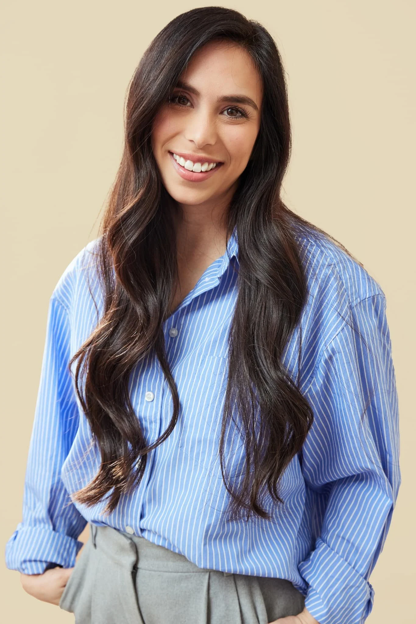 Portrait of Andria, founder of The Salt & Serenity, smiling in a neutral studio setting.