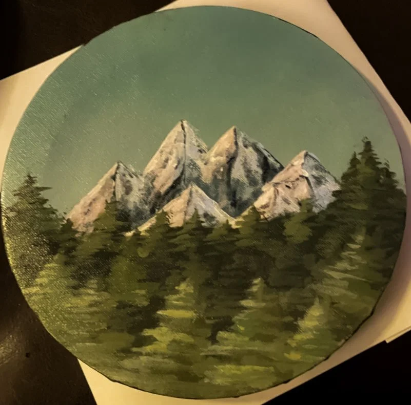 Painting of snow-capped mountains with pine trees in the foreground against a greenish sky.