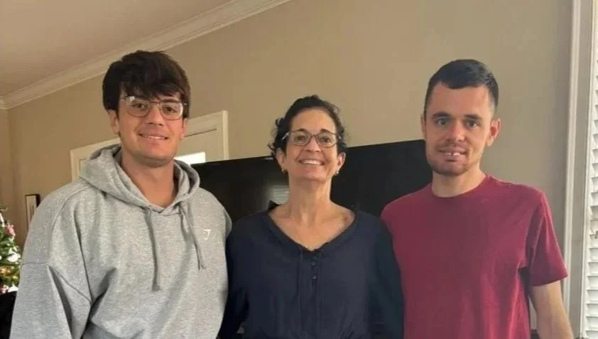 Amy standing between her two sons