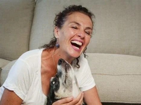 Mitch laughing and cuddling her dog Star