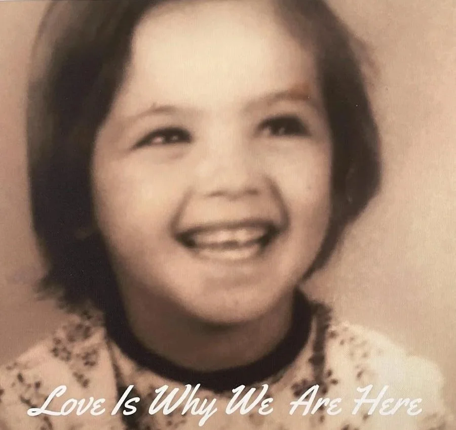 Black and white childhood photo of Mich Carpenter smiling