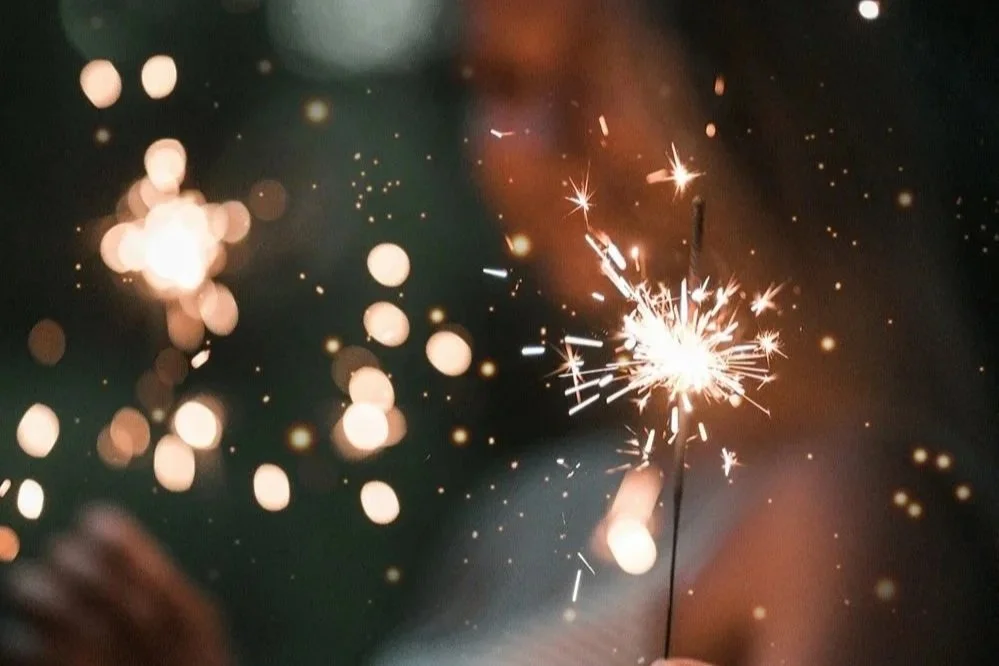 A close-up shot of a sparkler with the background soft and out of focus.
