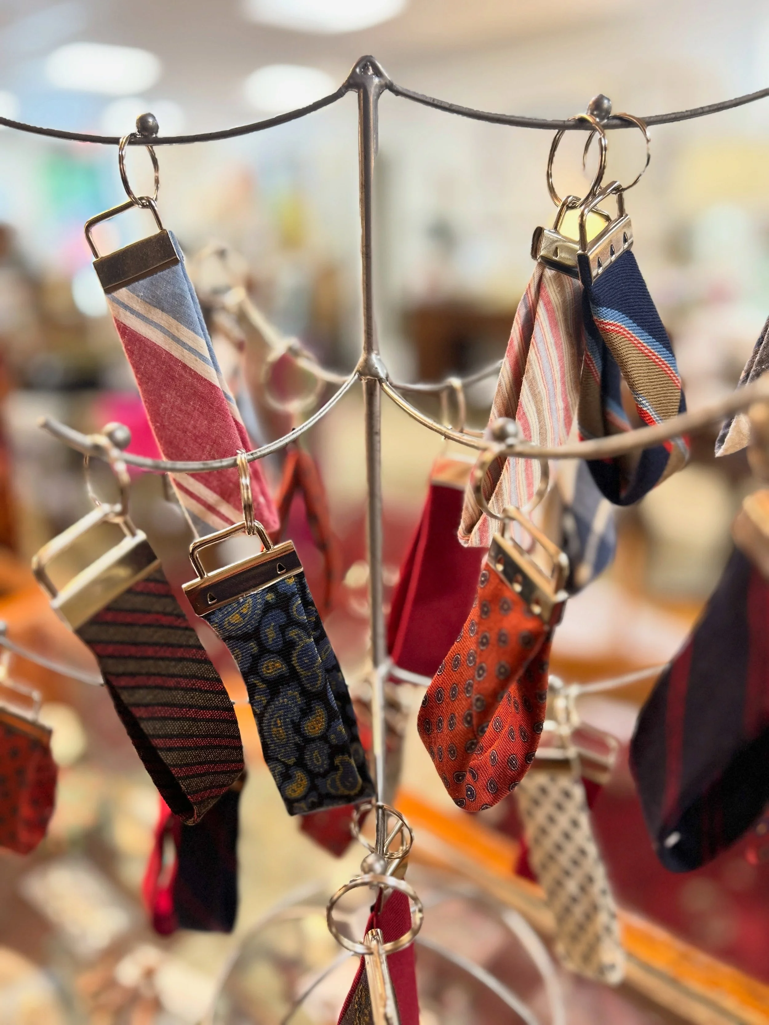 We have tons of vintage silk and wool ties, but some couldn&rsquo;t be displayed due to stains or wrinkles or other issues. So we salvaged the parts we could and made tow styles of keychains or bag charms/tags. Limited availability on this first batc