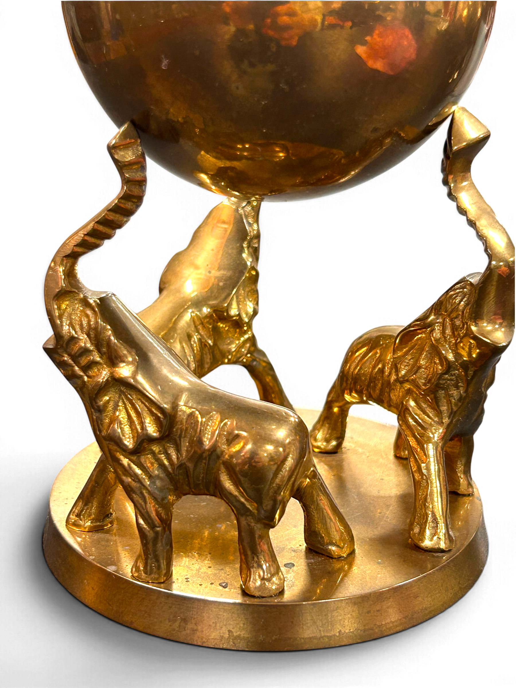 three-elephant-sculpture-raised-trunks-detail.png