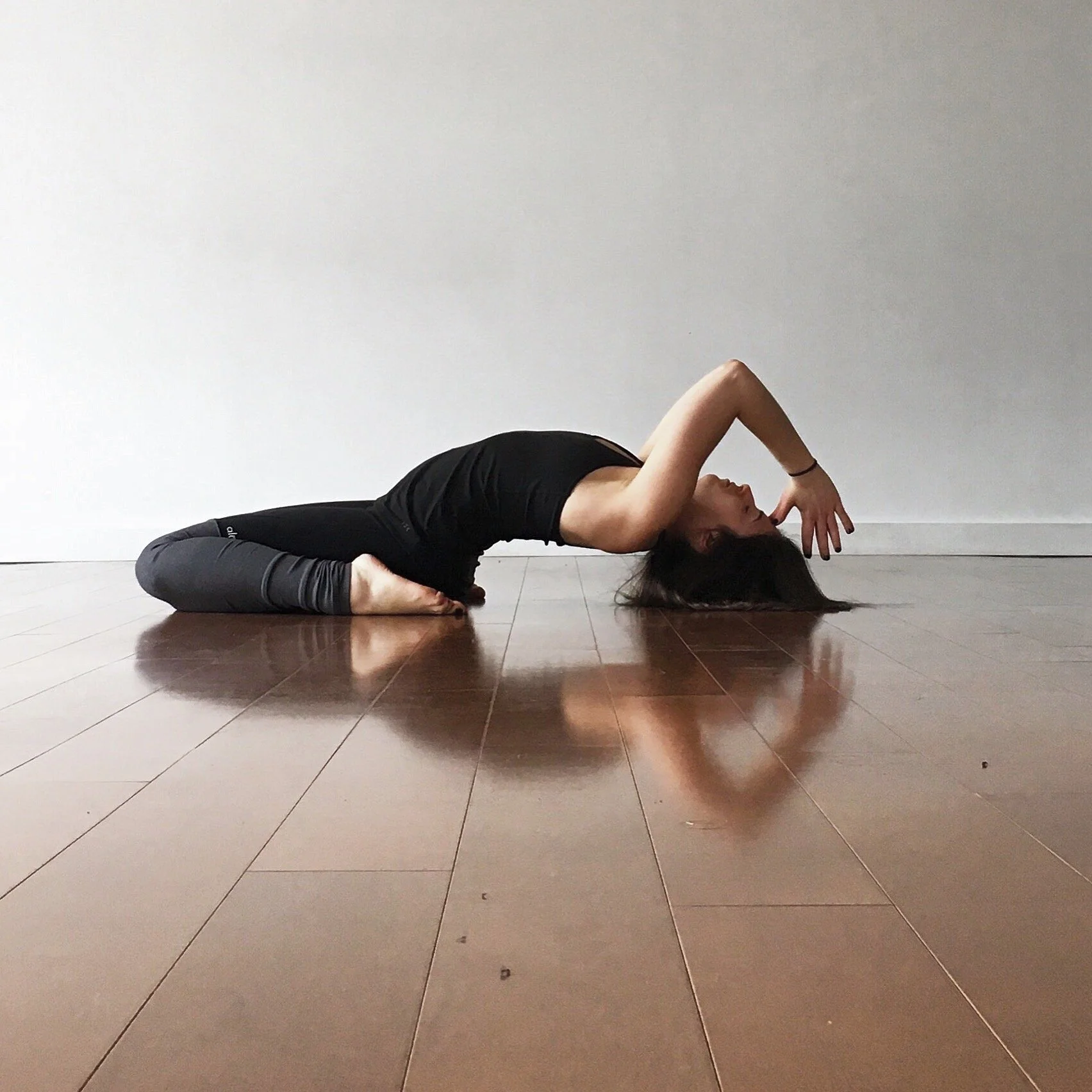 Jessica Reis practicing yoga in a studio
