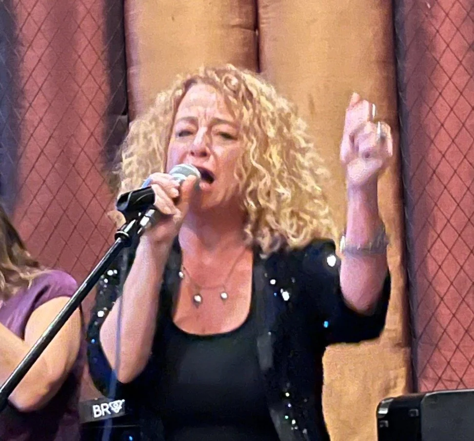 Gia singing Club Car cropped.JPG