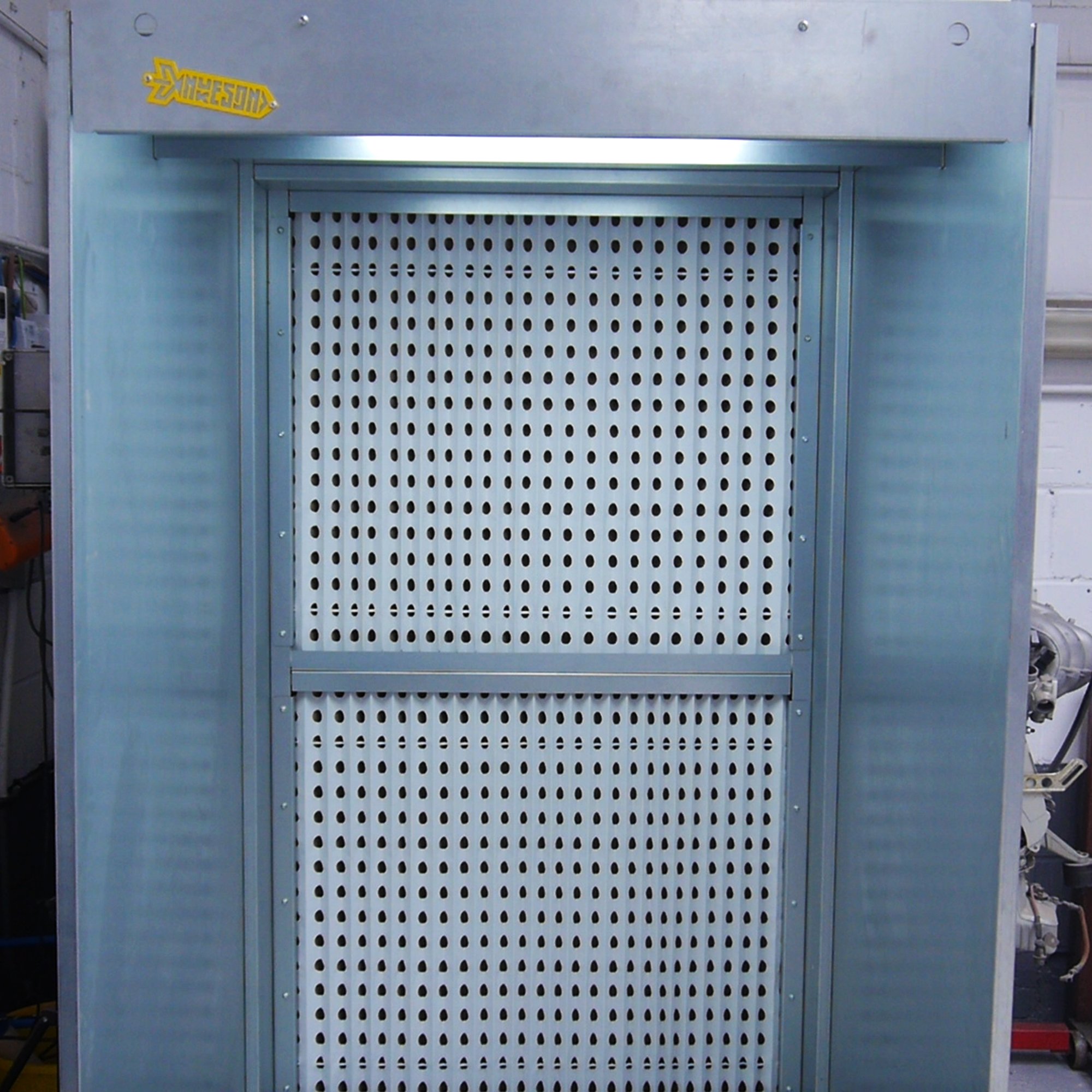 A metallic enclosure with a perforated metal panel in the center, labeled with a yellow sticker that reads "Awesome" in the top left corner.