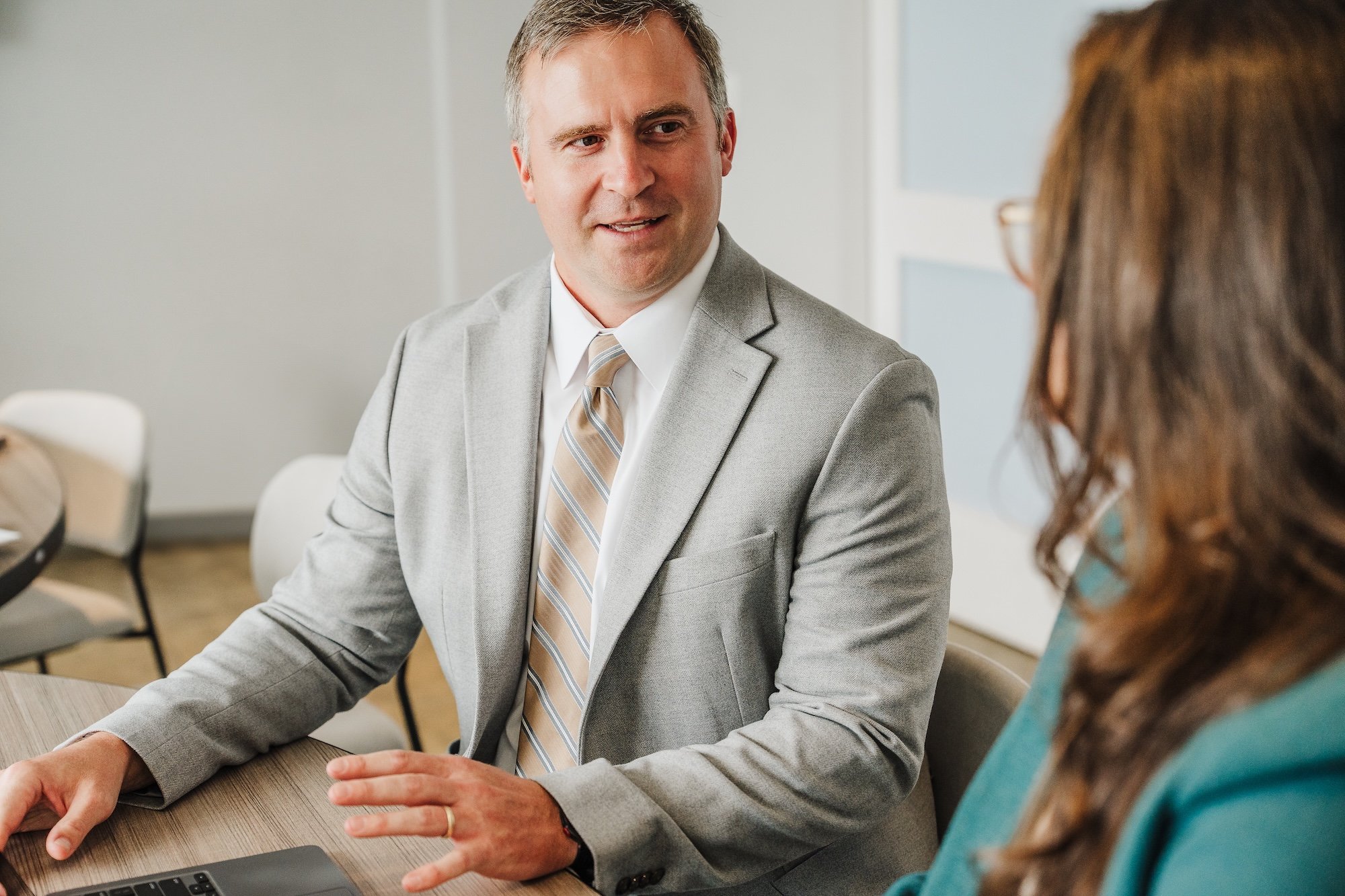 Professional coach facilitating transformational conversation in warm environment