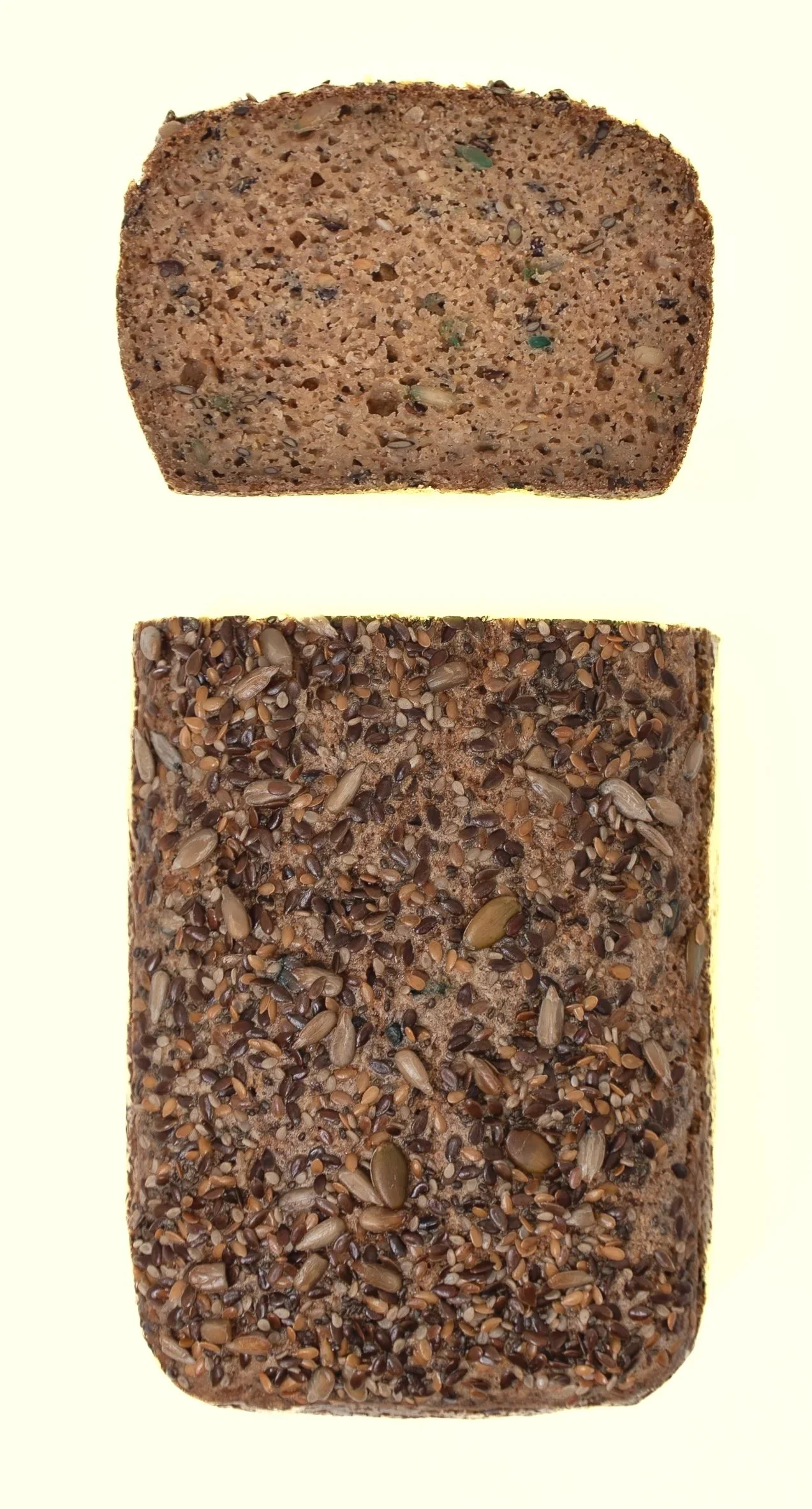 Image of two slices of multigrain bread, one plain and one topped with mixed seeds.