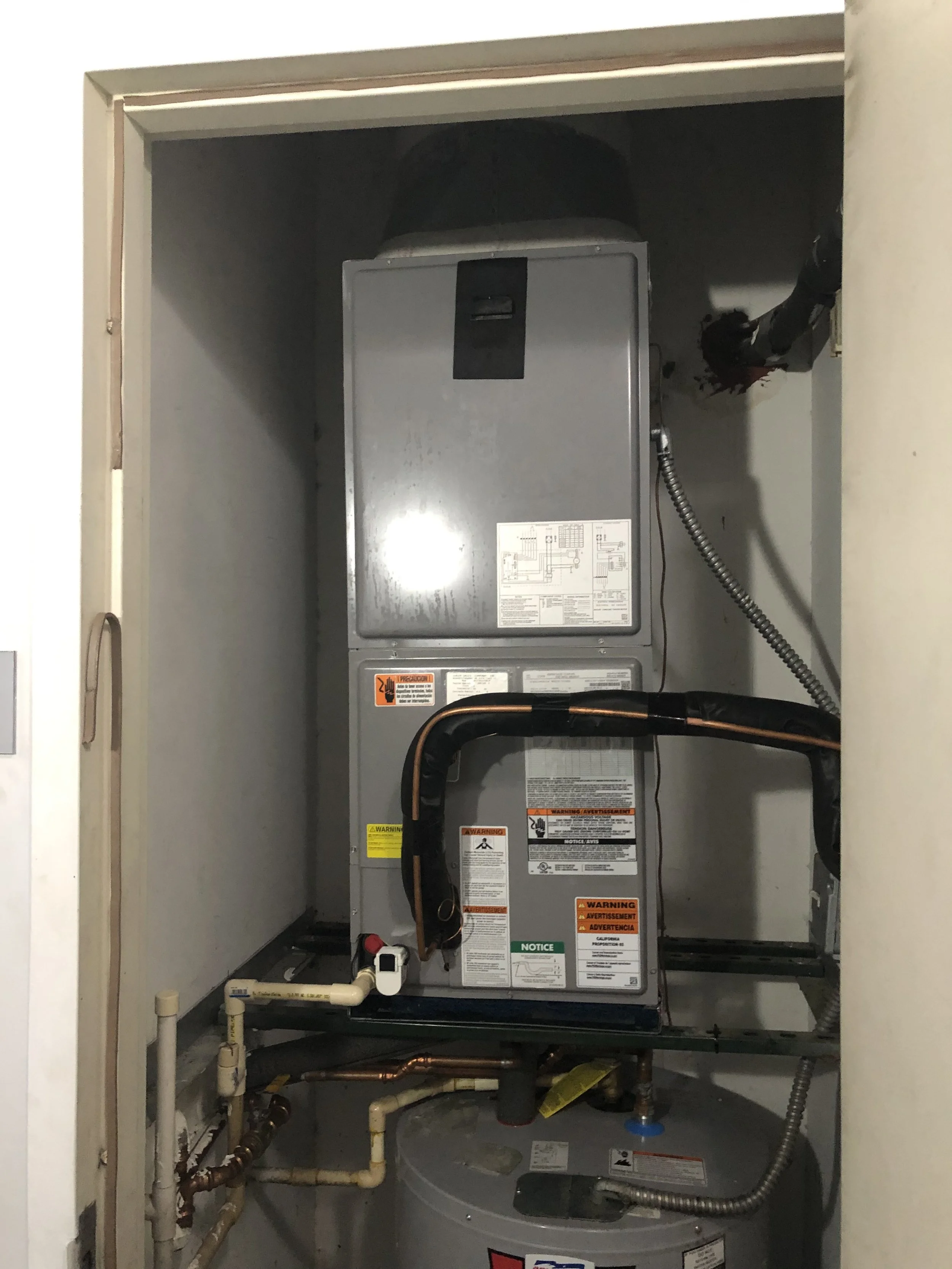 Indoor air handler and water heater setup for an HVAC system in Miami, FL. Installation ensures efficient airflow distribution and consistent indoor temperature control.