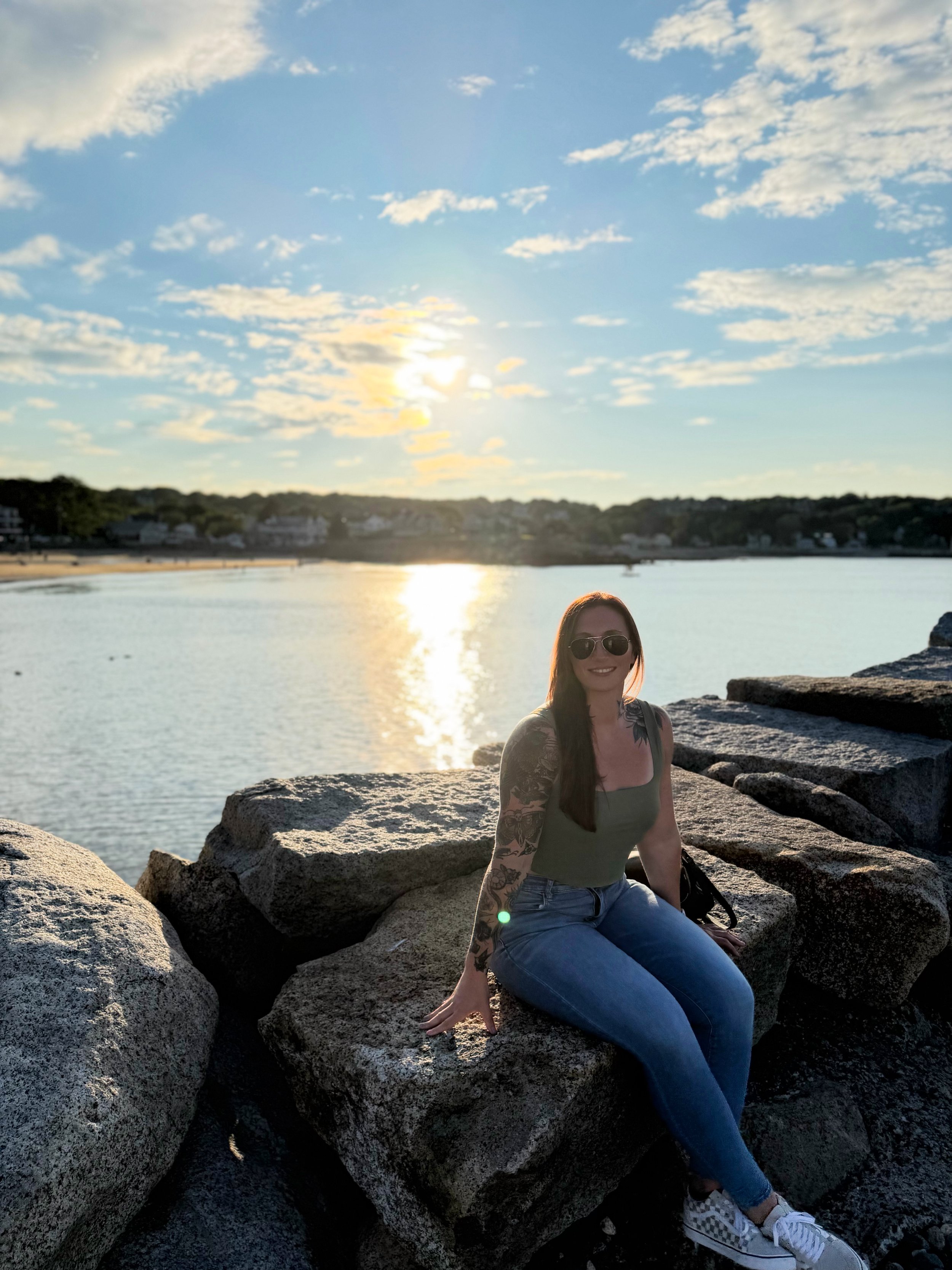 Natalie, founder and coach at Next Level Coaching with Nat, enjoying time outdoors by the water.