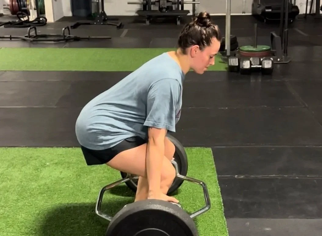 Next Level Coaching client Mackenzie building strength through personalized postpartum fitness coaching.