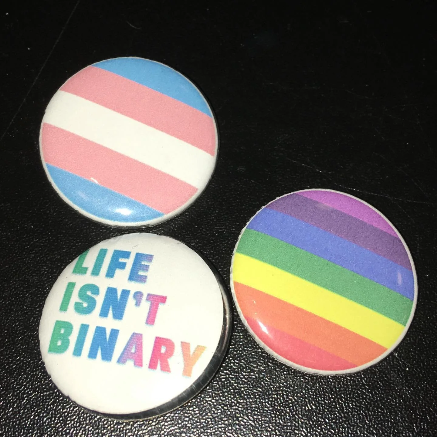 trans flag, pride flag, and life isn't binary text pins