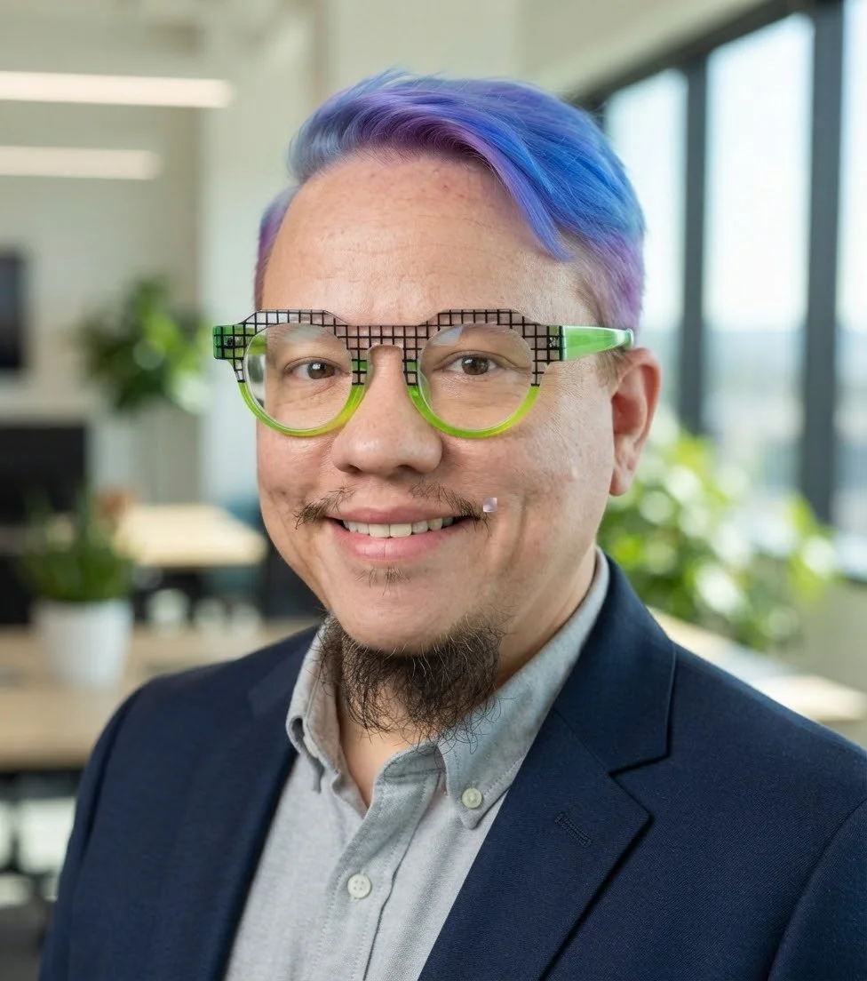 photo of Lawson a light skinned person with short blue and purple hair, green glasses, and wearing a blue jacket and grey shirt