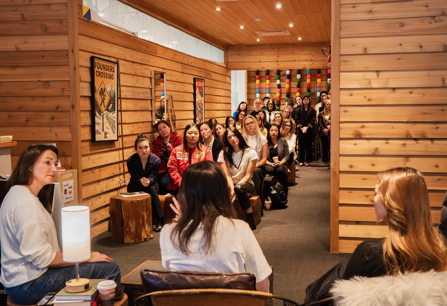 A packed founder conversation in North House’s cedar-lined gathering space