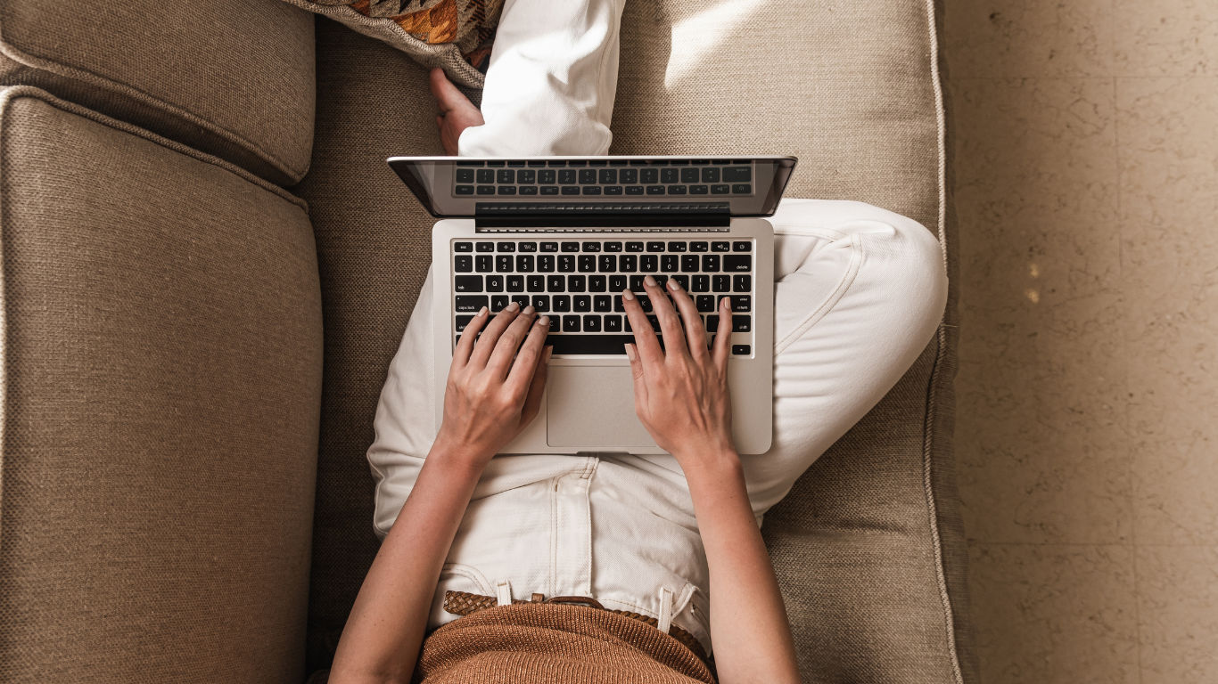 Person on a couch with laptop — online chronic pain and chronic illness therapy with Dr. Sarah Williams