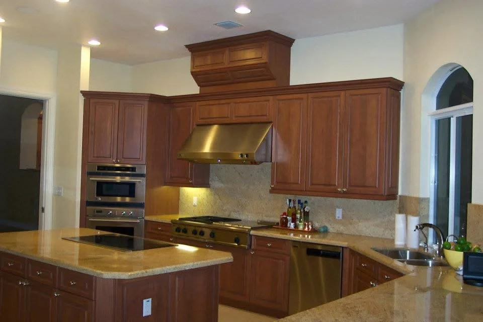 Kitchen with wooden cabinets, granite countertops, stainless steel appliances including oven, microwave, and dishwasher, and a window above the sink.