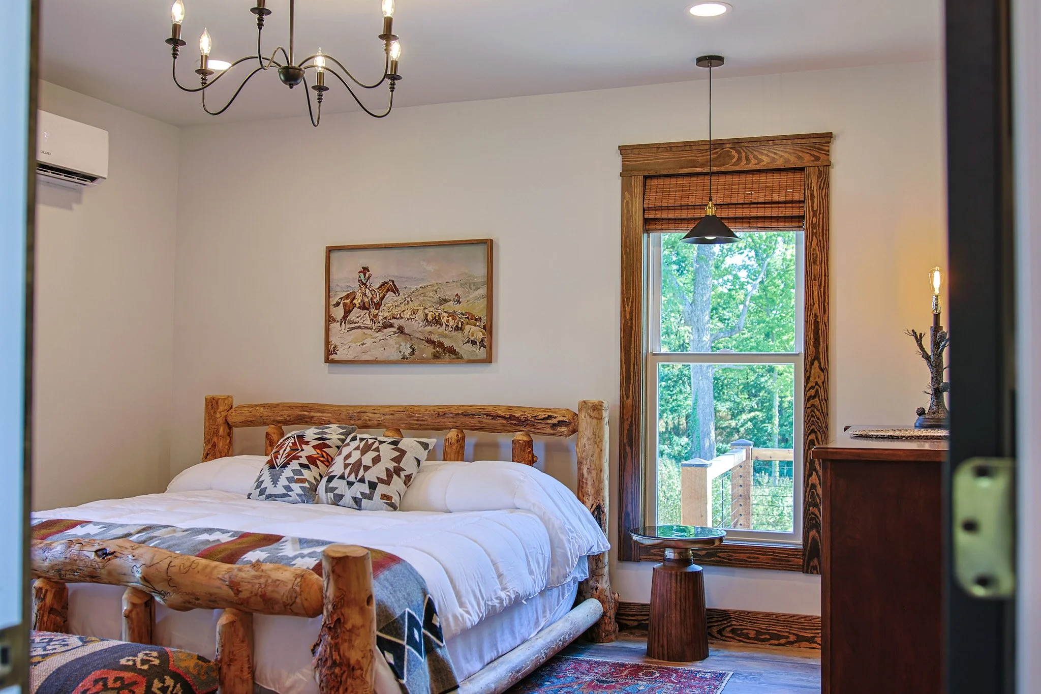 king size bed with custom wood trim cowboy painting above bed