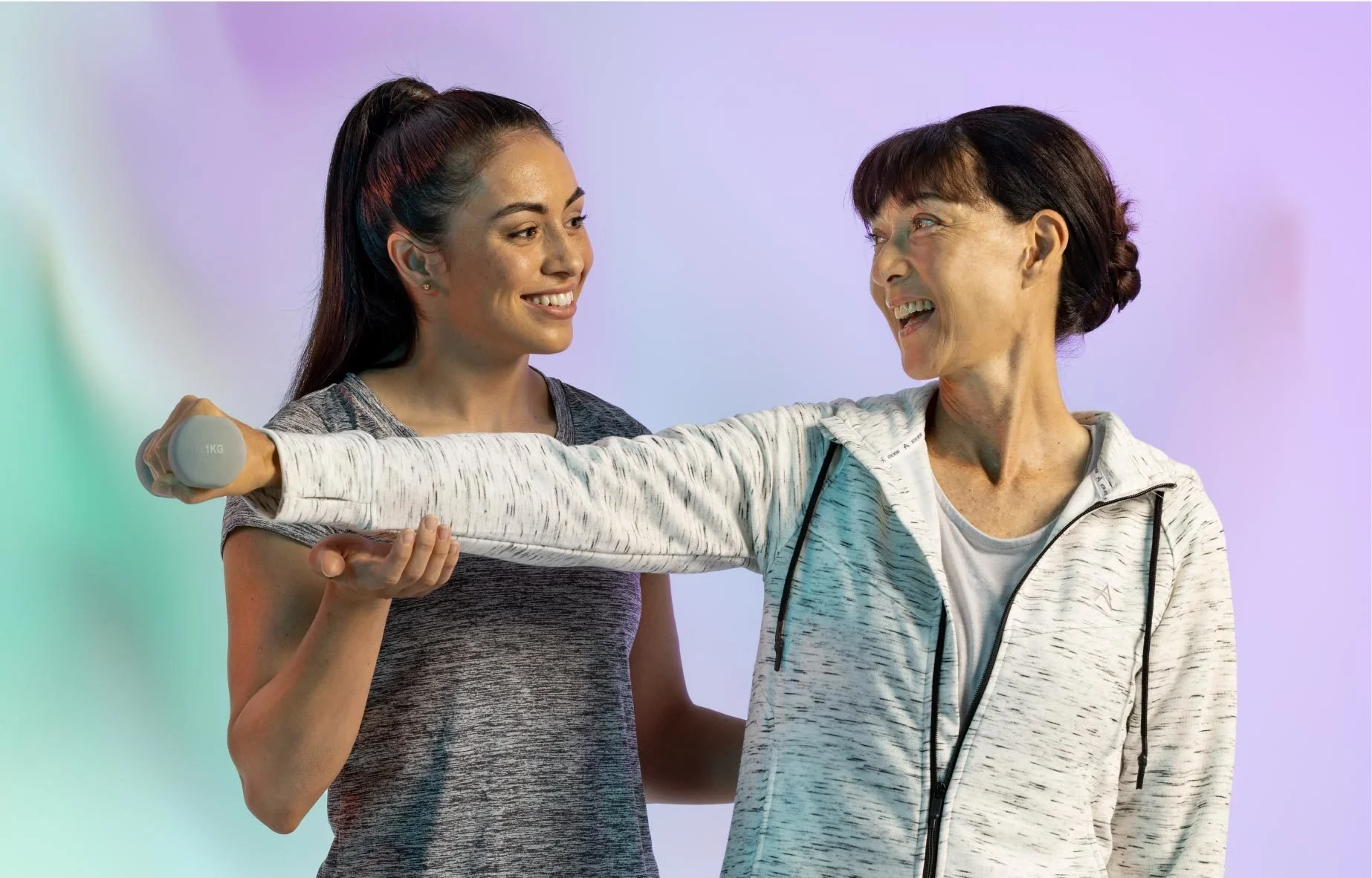 Personal trainer assisting her client in Nutiani photo shoot.