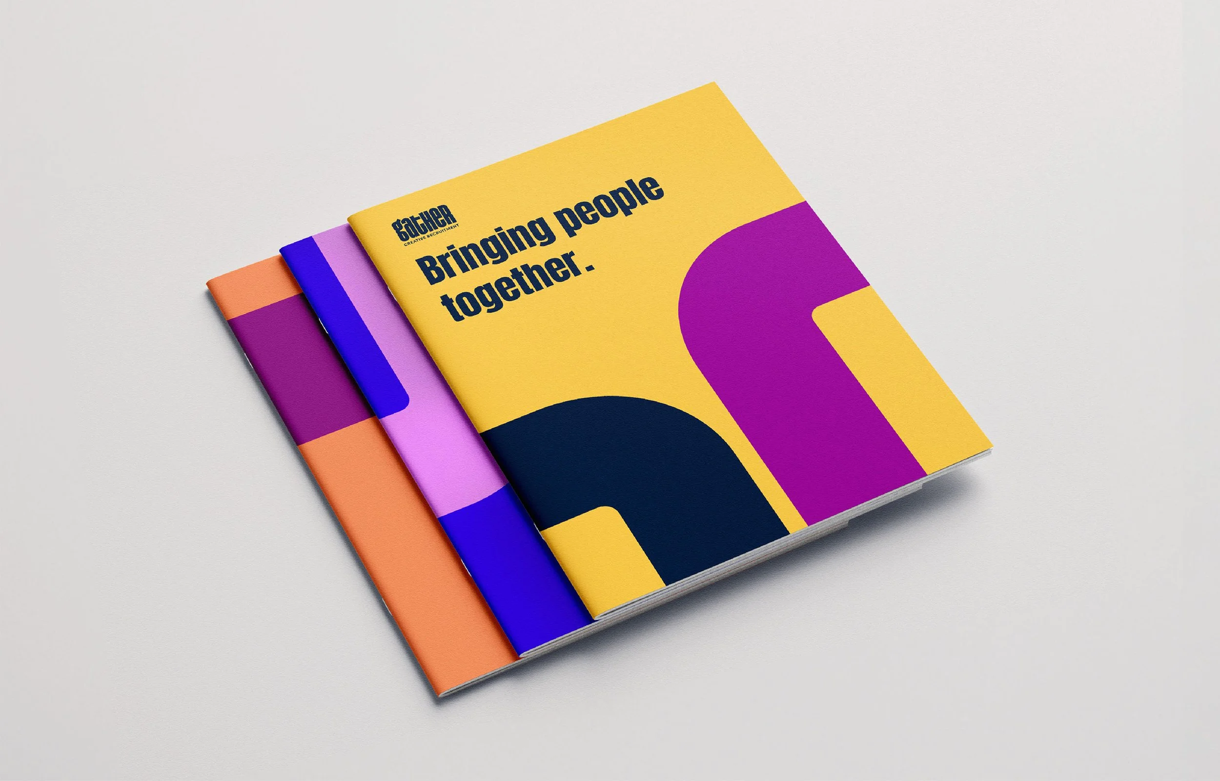 Three colorful brochures stacked, with the top yellow brochure reading "Gather" and "Bringing people together." in bold text.
