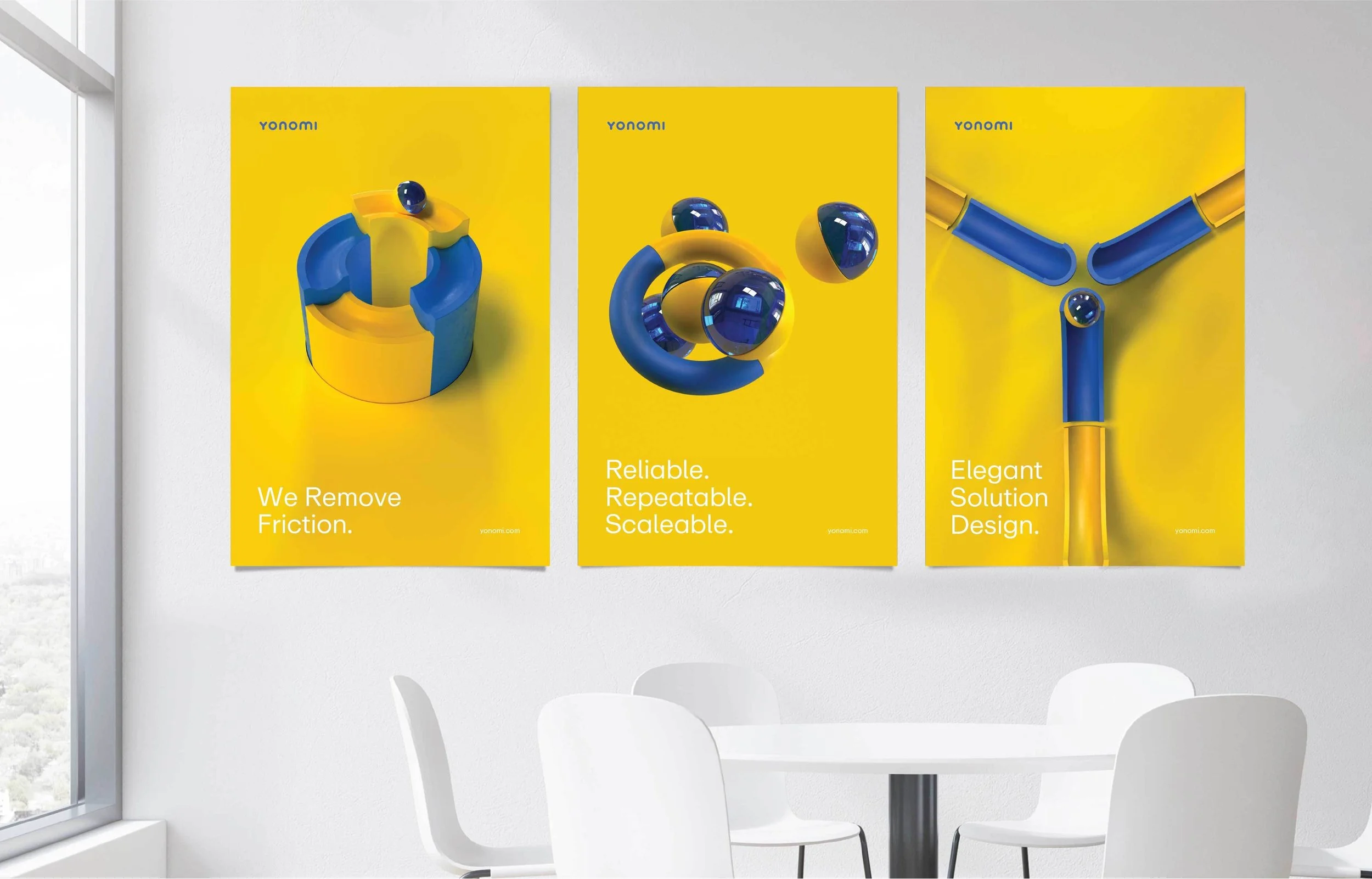 Three yellow posters with blue and yellow abstract sculptures and minimal text, displayed on a white wall in a modern office setting.