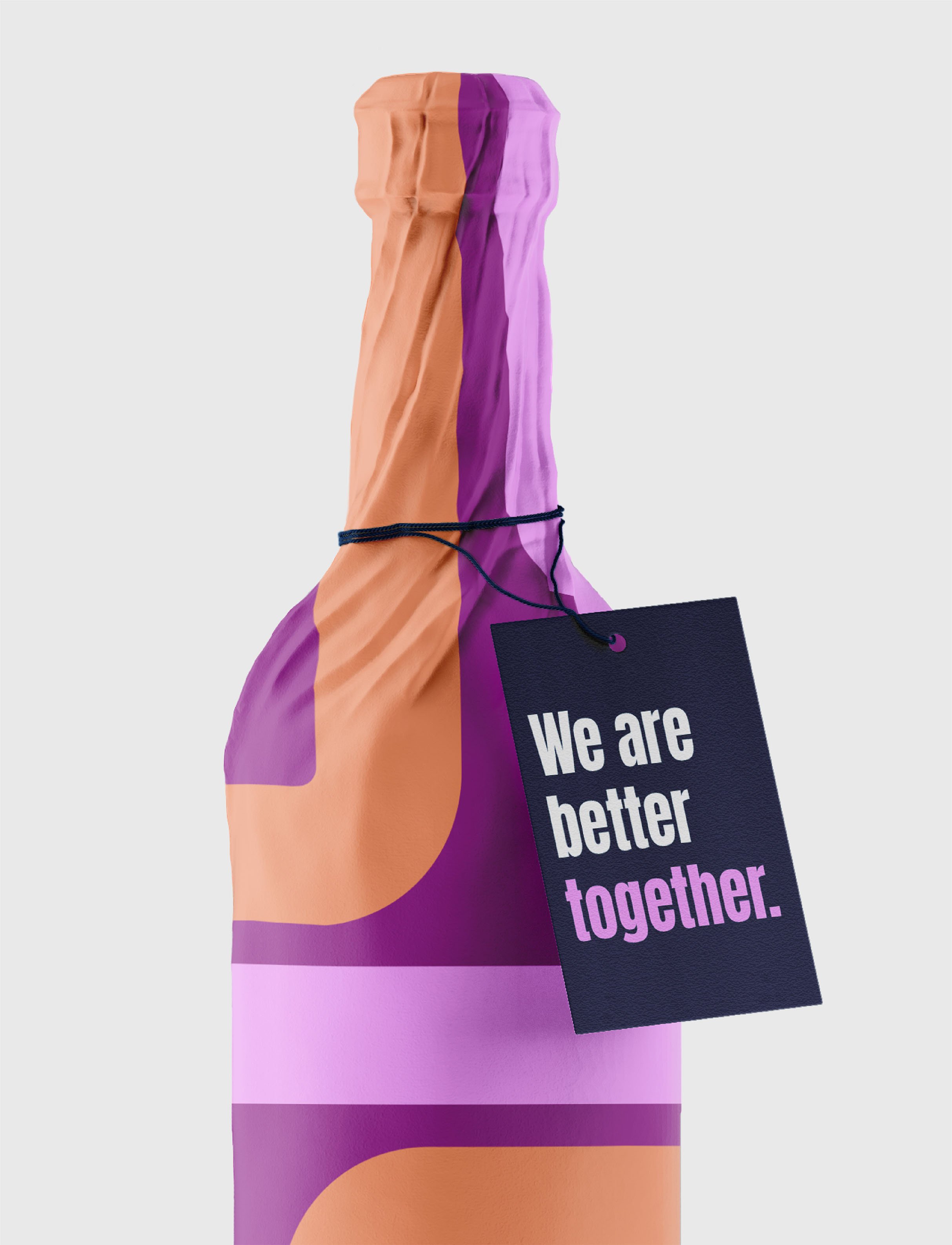 A wrapped gift box with a predominantly purple and peach abstract pattern and a black tag attached that reads, 'We are better together.'
