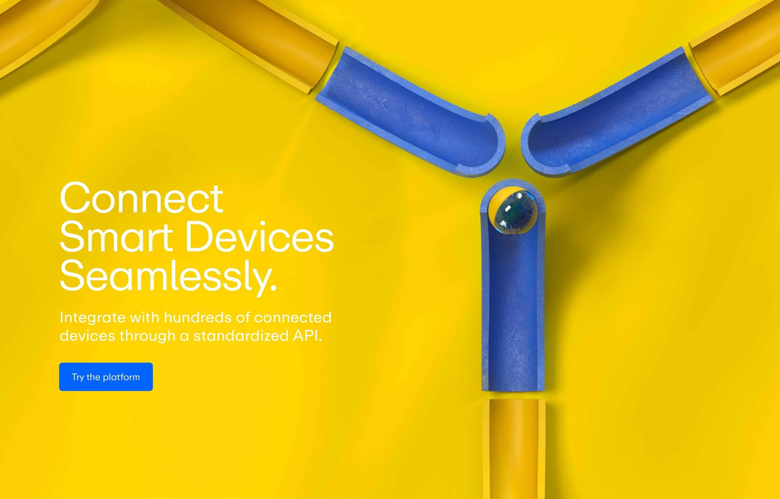 Bright yellow background with blue and gold pipes arranged in a 'Y' shape. There is a small black ball at the center where the pipes meet. White text on the left side reads, 'Connect Smart Devices Seamlessly. Integrate with hundreds of connected devices through a standardized API.' A blue button below the text says, 'Try the platform.'