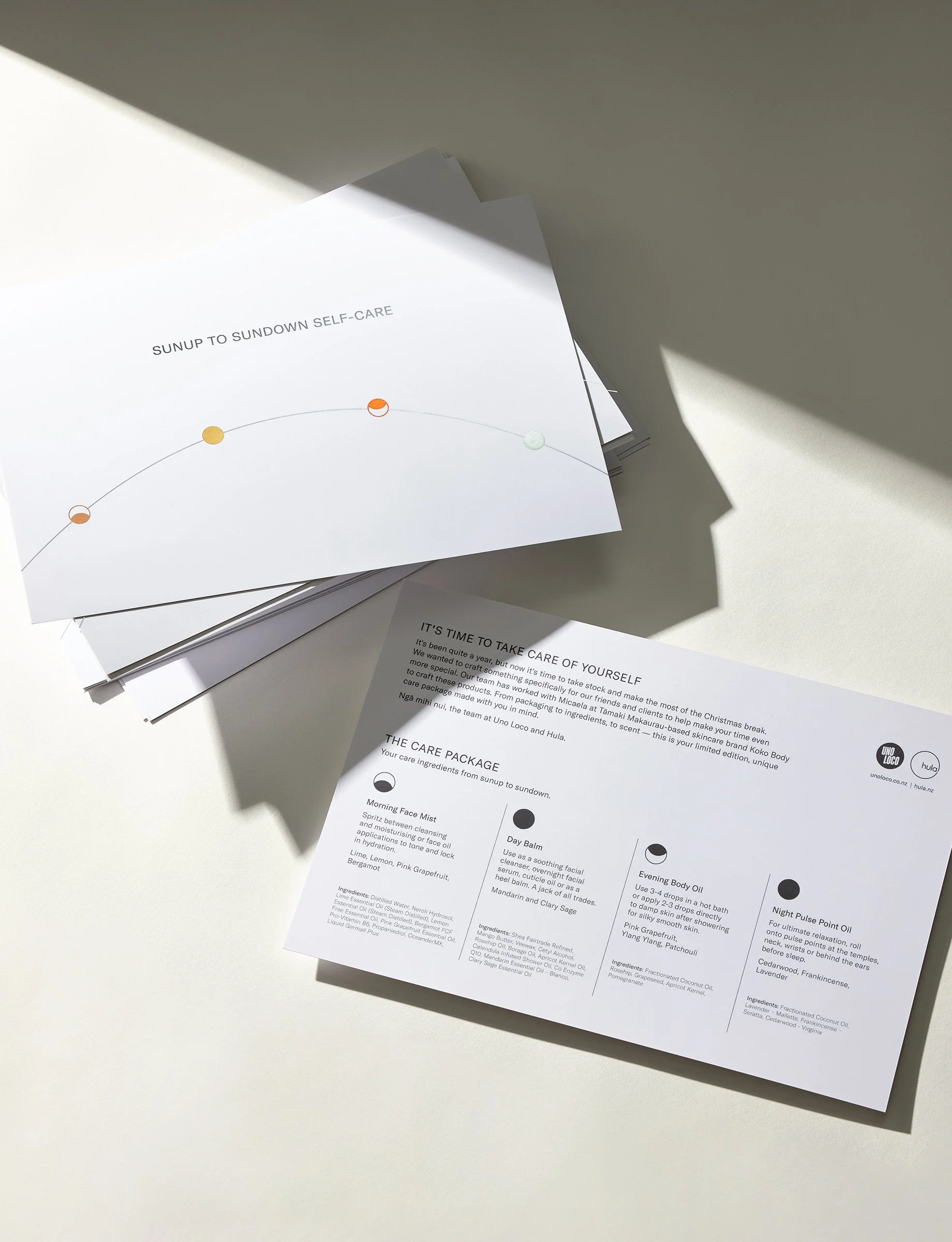 Stack of informational leaflets or brochures on a white surface, with some shadow and sunlight.