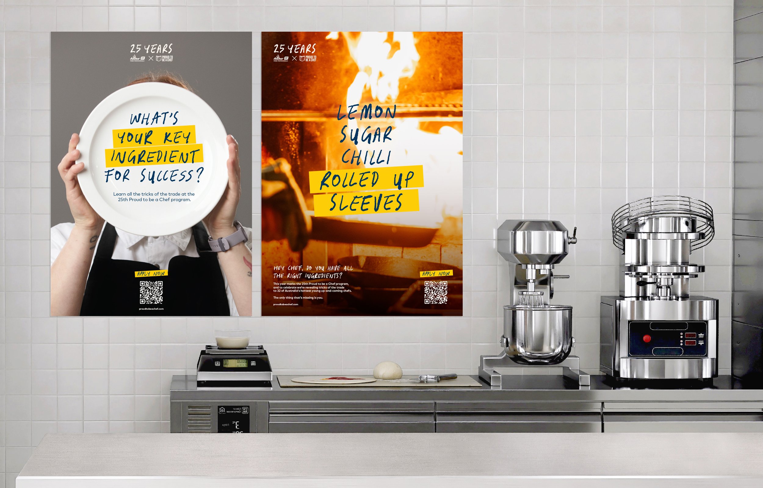 Kitchen with two posters on the wall promoting a chef program, a digital scale, a ball of dough, and commercial kitchen appliances on a stainless steel counter.