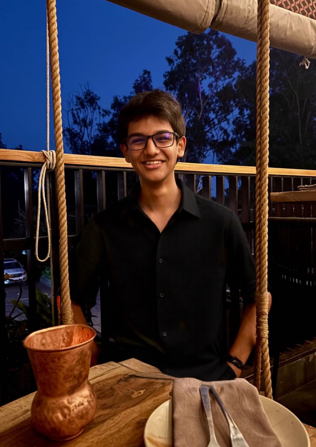 Young man with dark hair smiling