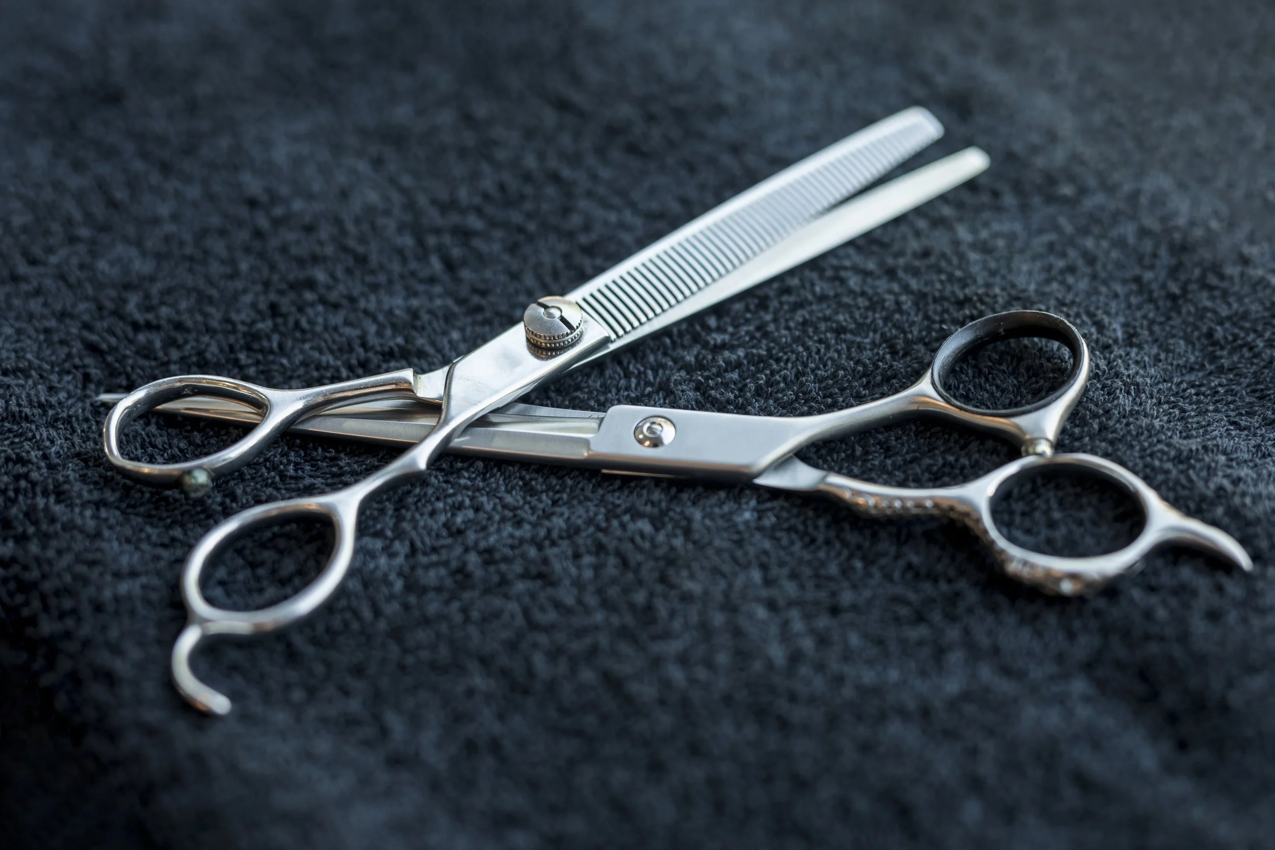 hairdressers-scissors-lying-dark-cloth.jpg