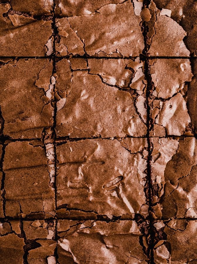 Close-up of a cracked and weathered clay surface with grid pattern