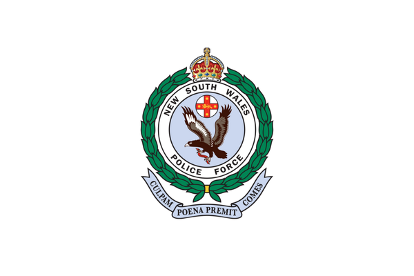 Emblem of the New South Wales Police Force featuring a crown, a wreath, a bird, and a banner with Latin motto.