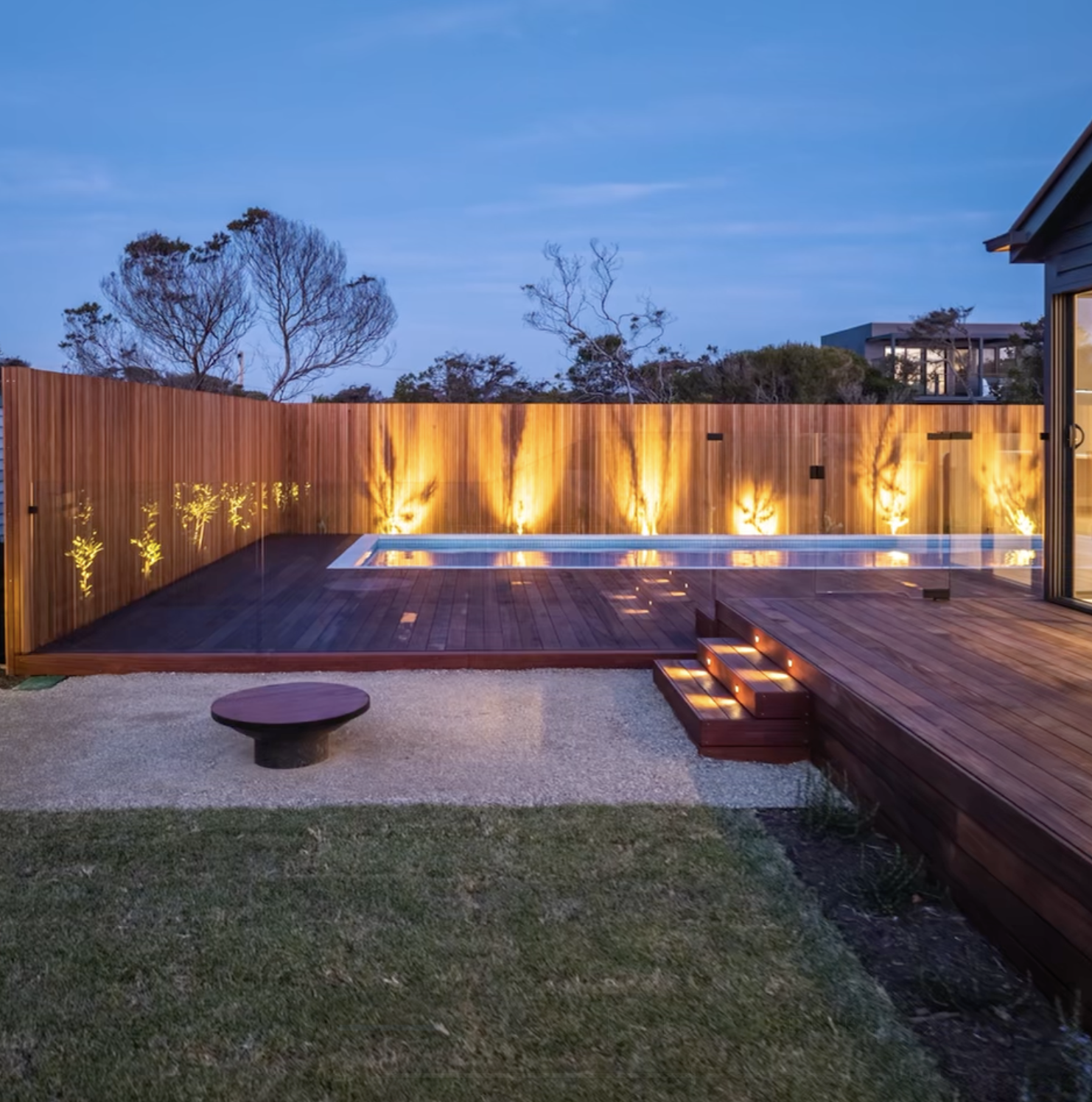 Backyard scene at dusk with swimming pool, built-in lighting.  Garden lighting around pool, outdoor feature lighting, high end garden lighting, Blairgowrie, Mornington, sorrento, 