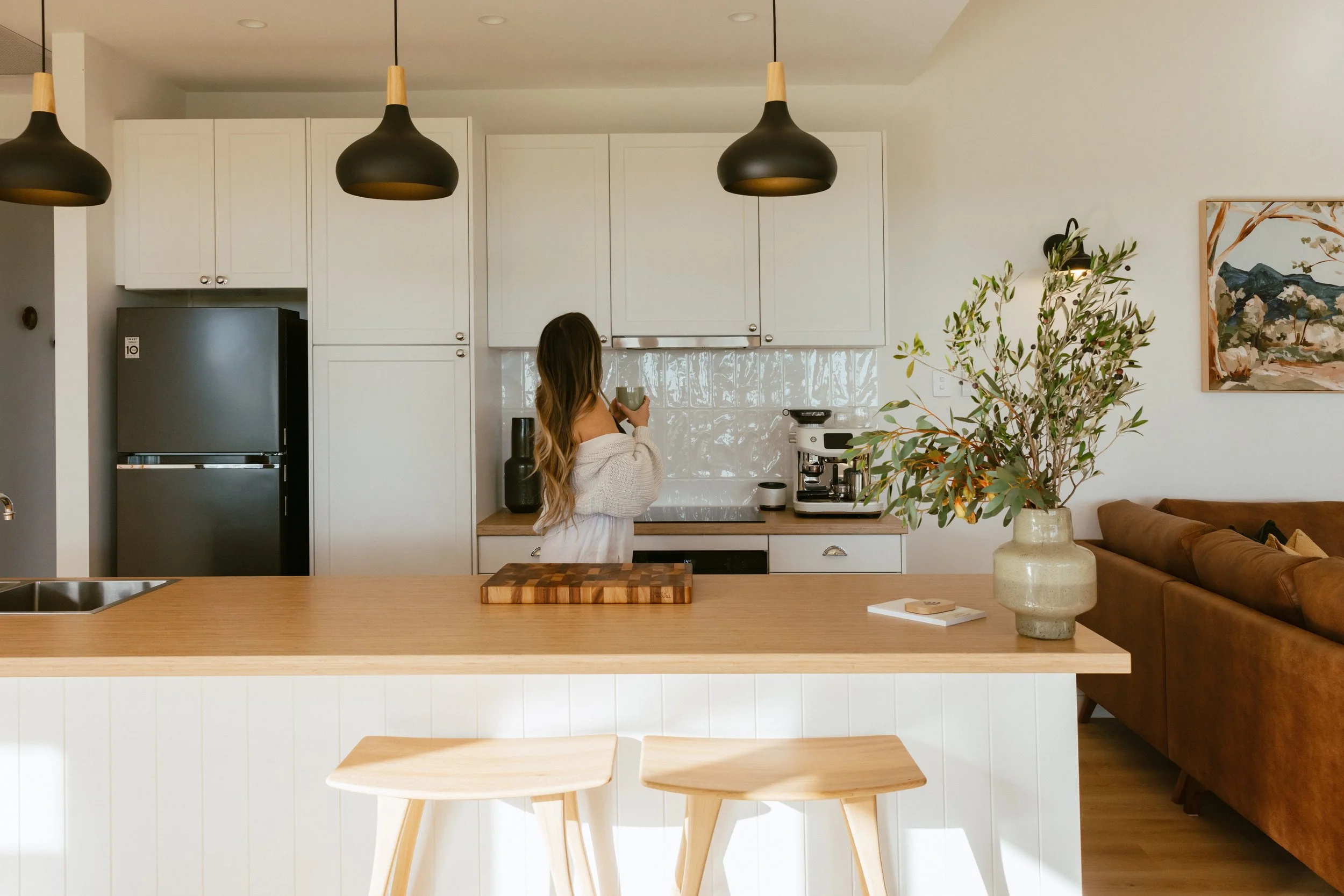 Fully equipped kitchen with island bench, full size fridge/freezer and espresso coffee machine