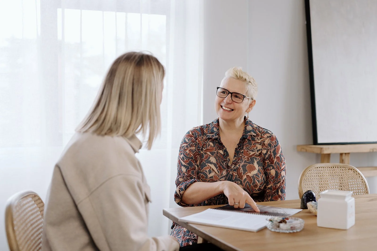Owner, Marie talking a client through their healing schedule with her