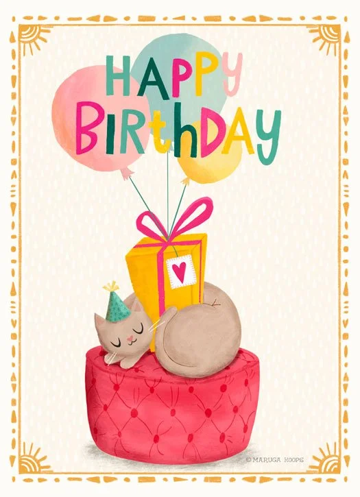 Cute illustration of a birthday celebration with a gray cat wearing a party hat, a large pink gift box with a heart, and two balloons spelling out 'HAPPY BIRTHDAY' in colorful letters, all on a red cushion with a decorative border.
