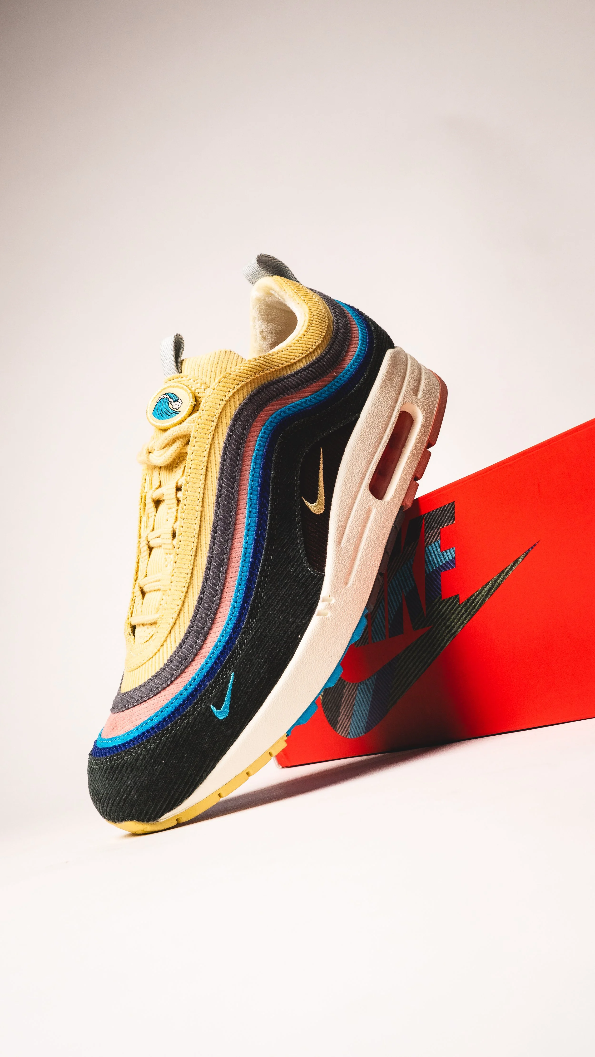 Close-up of colorful Nike sneakers stacked against a pale background