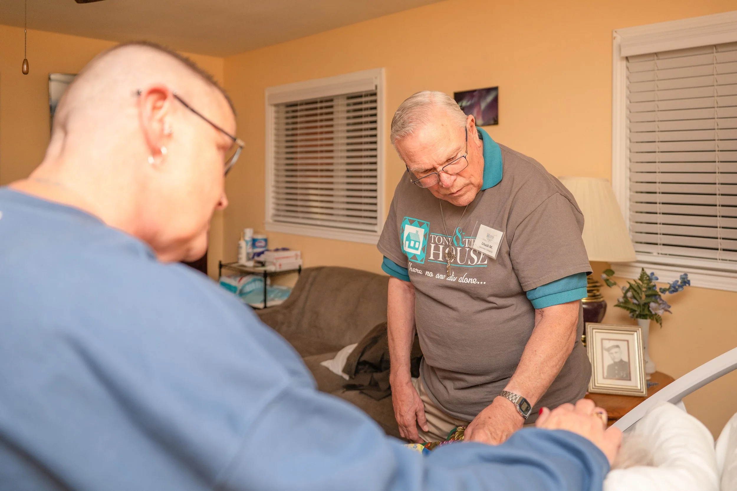 Volunteers comfort a guest at the Toni & Trish House
