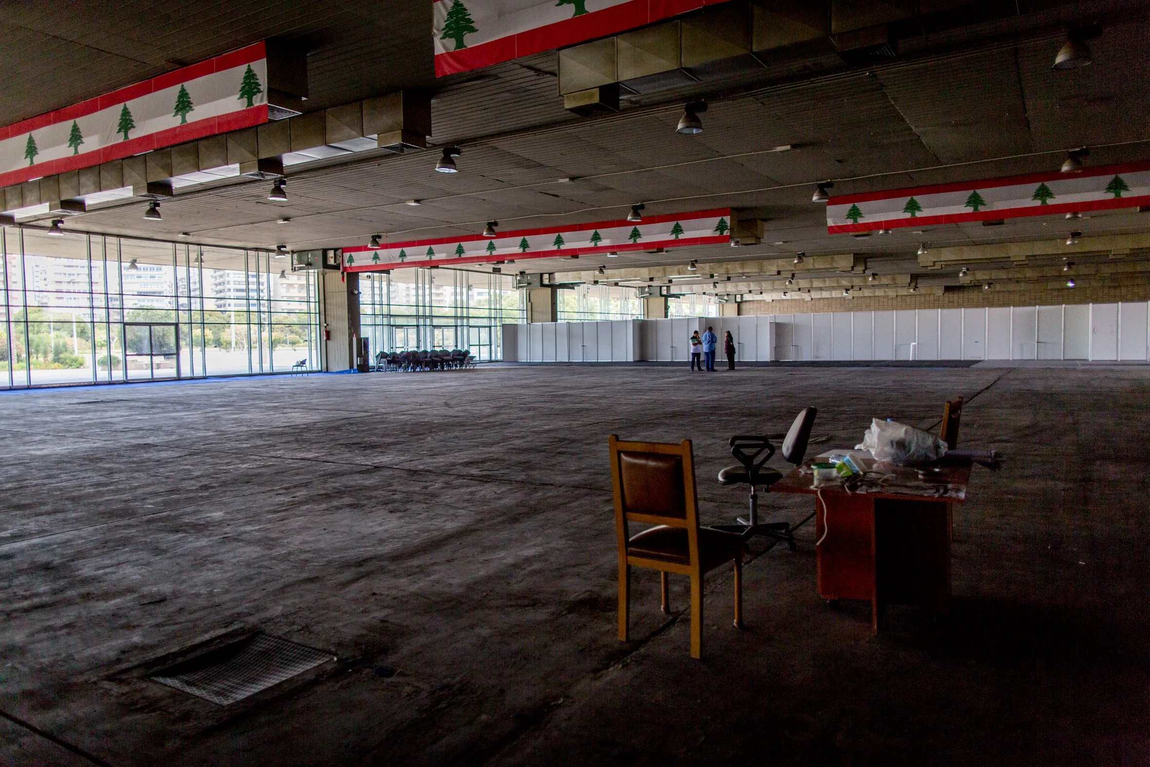 The interior of the main exhibition hall with Lebanese flags.