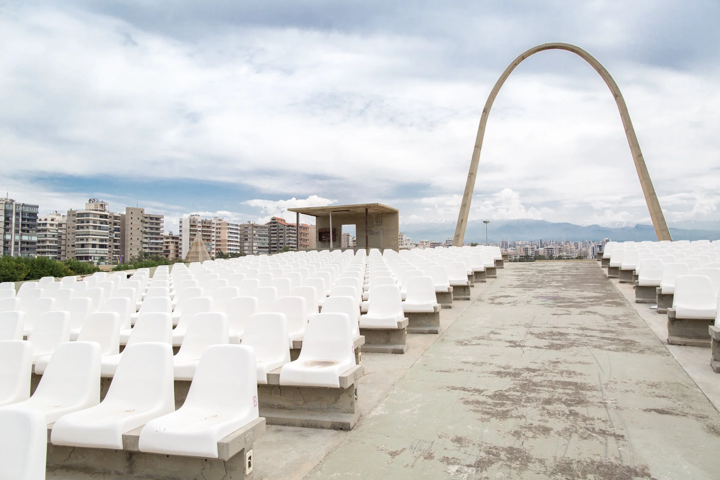 The open-air theatre and concrete arch. The seating was reconstructed after the civil war. 