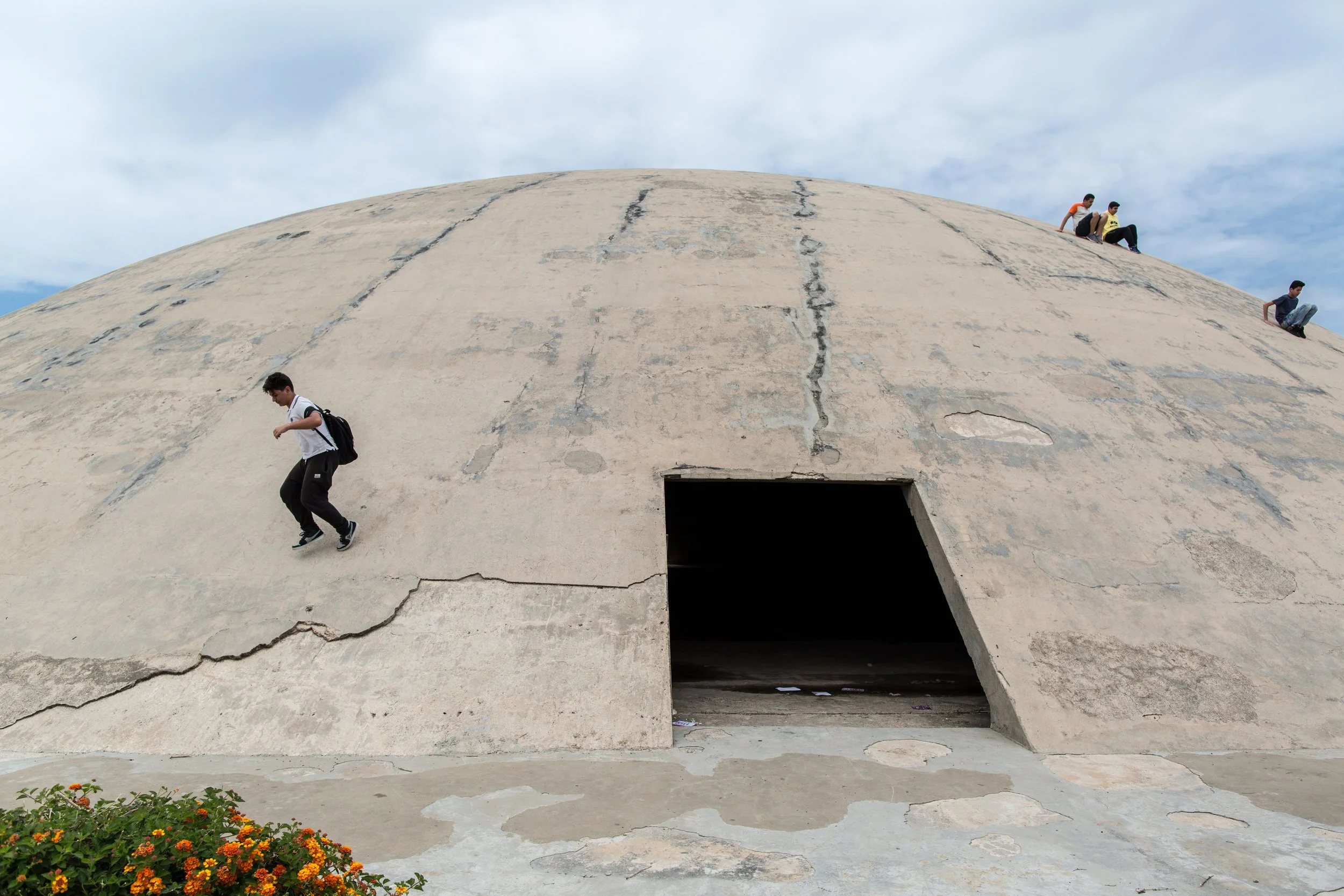 Kids playing on the dome intended by Niemeyer as an experimental theatre. It was later used a weapons dump by the Syrian army during the Lebanese civil war. 