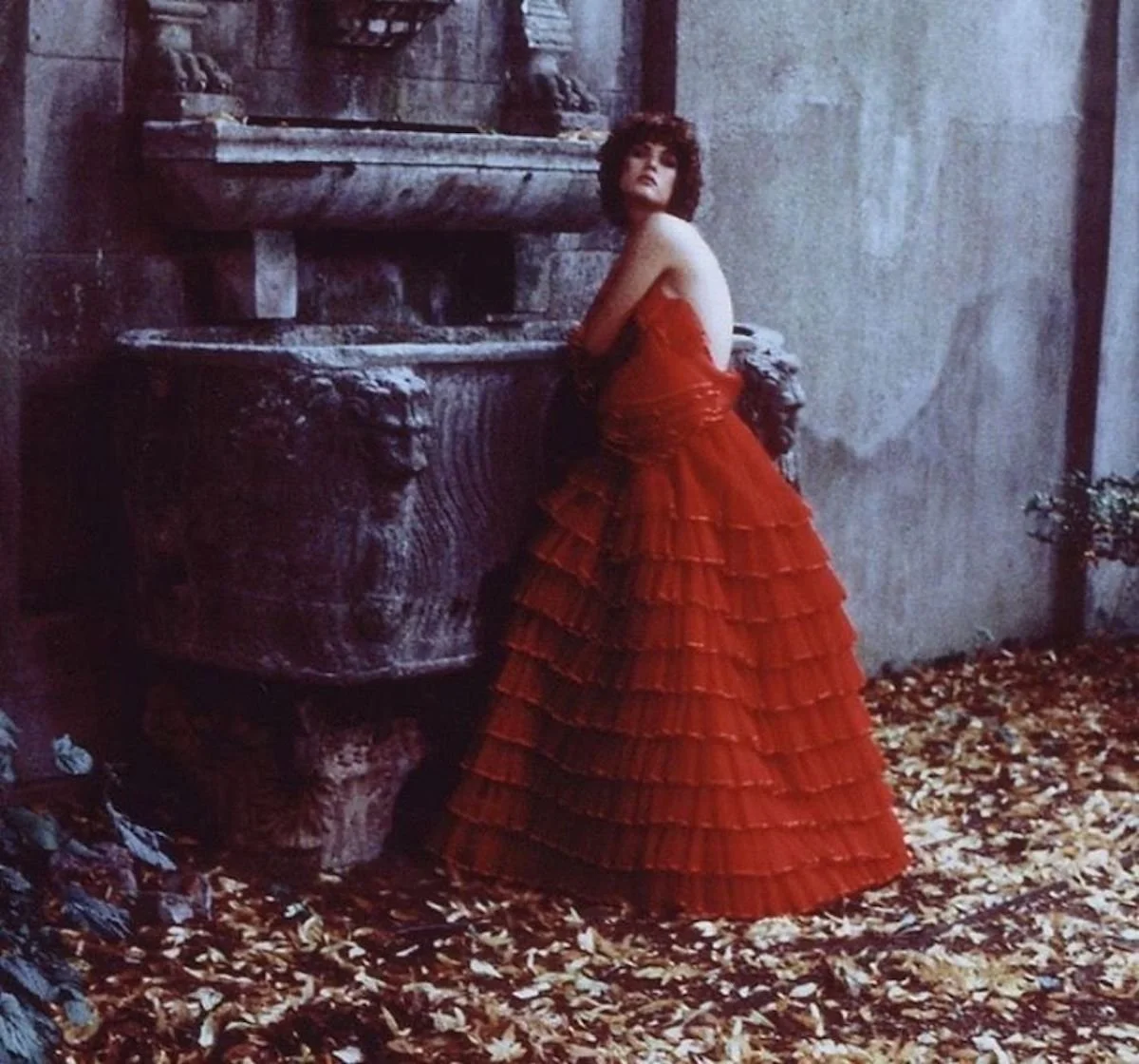 Isabelle Weingarten in red Valentino, Fontana del Mascherone, Via Giulia, Rome