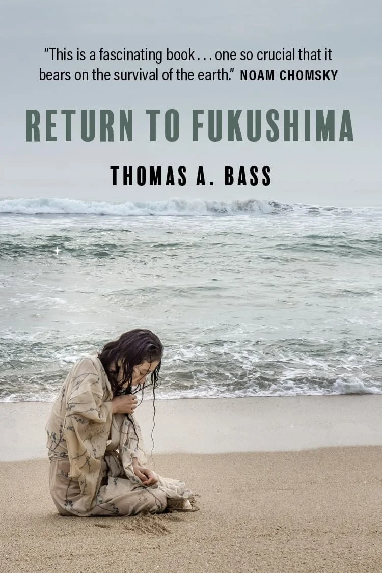 A woman sitting on the sandy beach near the ocean, with her head bowed and hair wet, as waves approach the shore. The cover of a book titled 'Return to Fukushima' by Thomas A. Bass, with a quote from Noam Chomsky, is overlaid at the top of the image.